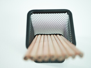Pencils neatly arranged in a modern black mesh holder, ideal for office and creative projects