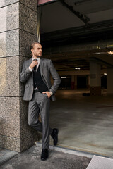Handsome man in a stylish suit enjoys a moment of relaxation outdoors