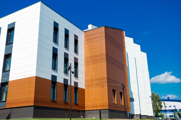 A modern building with a ventilated facade made of metal cassettes and porcelain stoneware. White,...