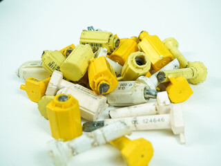 Bright yellow and white security seals scattered on a clean white background with numbered tags
