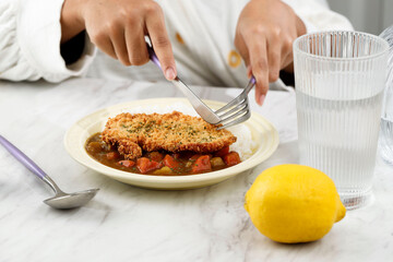 Holding Knife and Fork Eating Tonkatsu Curry