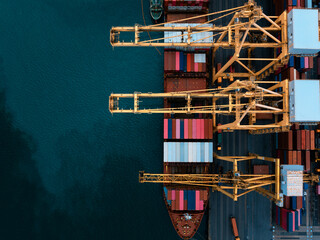 commercial port load and unloading cargo from container ship import export by crane for distributing goods by trailers transported to customers and dealers,