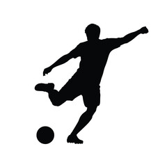 Silhouette of a soccer player kicking a ball in action