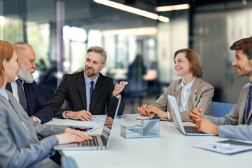 Group of modern people using modern technologies while working in the modern office