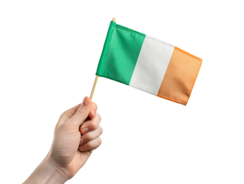 A hand proudly holds a miniature Irish flag against a backdrop of radiant light