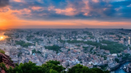 Panorama of a sunset over Barcelona, with the cityscape and a vibrant sky visible from a mountain viewpoint