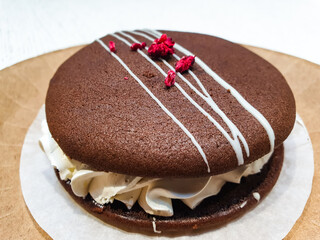 Chocolate brownie cake with a creamy layer and a berry. Dessert, sweet pastry.