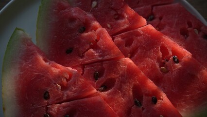 Watermelon wedges arranged on plate in natural light