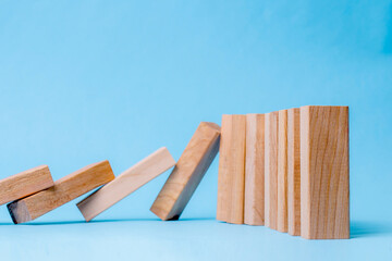 Wooden Blocks Tipping Over In Chain Reaction Toward Upright Blocks, Symbolizing Cause And Effect