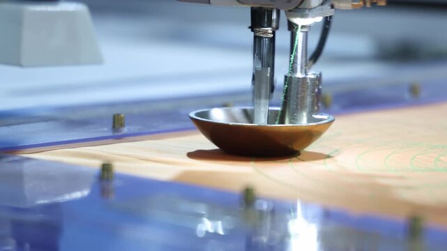 Sewing automate robot. Close up of industrial embroidery or sewing machine precisely stitching patterns onto fabric. Advanced automation in textile production and needlework with high technology.