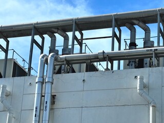 An elaborate network of large, insulated industrial pipes with labels 'CHR' and 'CHS', part of a...