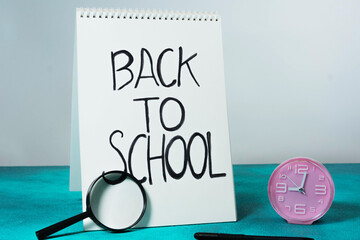 Back to School Concept with Clock and Magnifying Glass