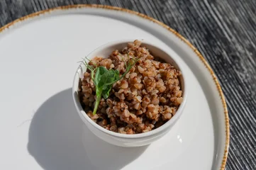 Gordijnen A plate of buckwheat in a cafe.  © Михаил Решетников