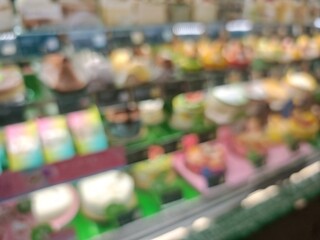 Abstract bokeh image of colorful, out-of-focus shelves in a retail store.