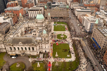 Aerial photograph of St. Patrick’s Day crowds filling the streets around Belfast City Hall during...