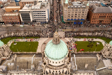 Aerial view of St. Patrick’s Day performers preparing on Belfast City Hall grounds as spectators...