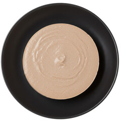 Creamy dessert spread in a round dish on a black plate with a smooth texture and minimal decoration