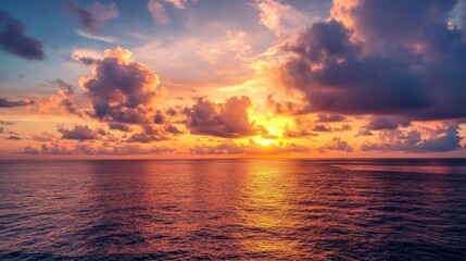 Fototapeta premium Stunning Maldivian sunset over ocean with dramatic clouds, tropical island paradise view, vibrant golden hour sky.