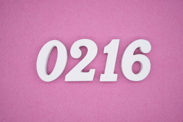 The numbers are made of white painted wood, placed on a pink paper background.