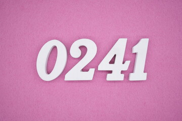 The numbers are made of white painted wood, placed on a pink paper background.