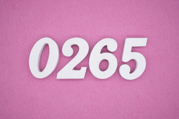 The numbers are made of white painted wood, placed on a pink paper background.