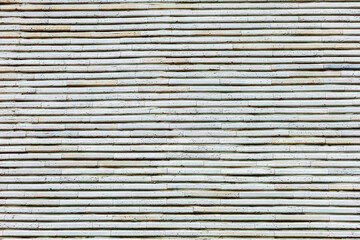 Light background of white wooden wall with horizontal structure, slightly worn, with natural wood texture. Texture of a bamboo mat
