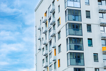 Modern residential complex with a clinker brick facade, large windows and balconies. Facade of a building