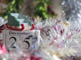 Santa's sleigh is placed on block date dated 25 December  waiting for fun festival Christmas and Happy New Year to make greeting card.