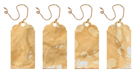 Vintage tags made of paper stained with coffee or tea. Each tag has unique marks and an uneven surface, hung on a string.