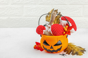 Halloween craft concept. Soft sewed fly agaric mushrooms, oak leaves, decorative berries