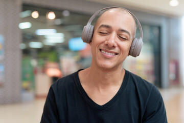 Man listening to music with headphones, relaxing and focused moment with eyes closed
