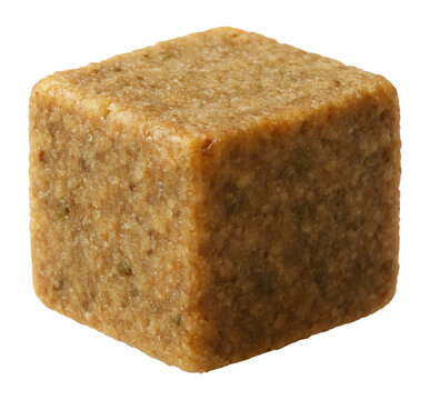 Square beige bouillon cube featuring a textured surface and a compact shape, commonly used for flavoring soups and stews, on transparent background.
