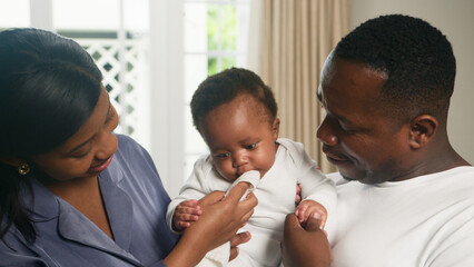 Loving Family Moments with Parents and Baby at Home in a Cozy Setting