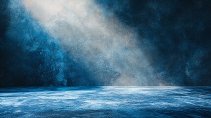Dark blue textured wall with light rays and floor, studio background