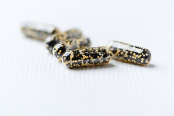 Iron capsules on bright background. Soft focus. Close up. Copy space.