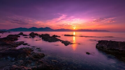 A vibrant sunrise over a tranquil coastline