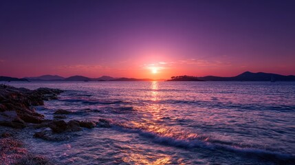 Stunning coastal view at sunset. Vivid colors fill the sky over the calm ocean