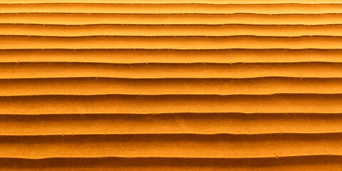 Textura de una pared con ondas tipo dunas con colores cálidos