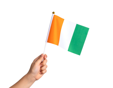 A hand holds the national flag of the Ivory Coast (Côte d'Ivoire), featuring vertical stripes of orange, white, and green.