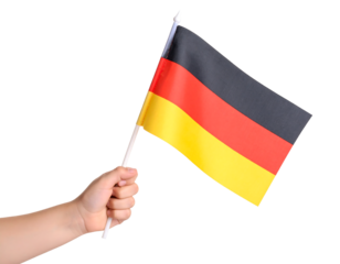 A hand proudly holding and waving the national flag of Germany.