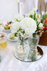 Beautiful bouquet of white flowers in a vase. Festive decor.