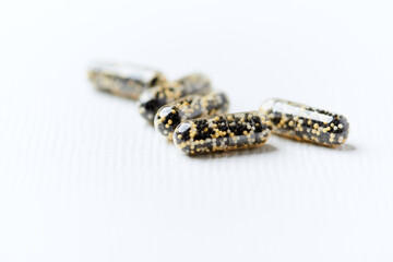 Iron capsules on bright background. Soft focus. Close up. Copy space.