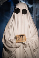 Happy Halloween. ghost in white sheet with 31 October calendar. Hello October and holiday