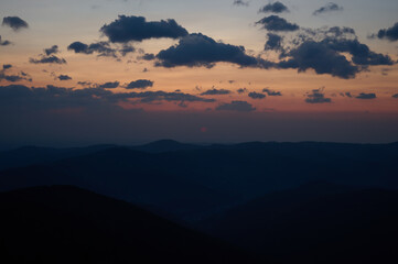 Beautiful morning view of mountains at sunrise. Amazing mountain landscape with colorful vivid sunset on the cloudy sky, natural outdoor travel background. Stunning morning mountain.