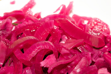 Close up of pickled chopped red cabbage on white background