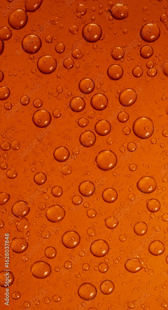 Poster close-up of orange liquid surface with many bubbles of varying sizes, creating a textured background