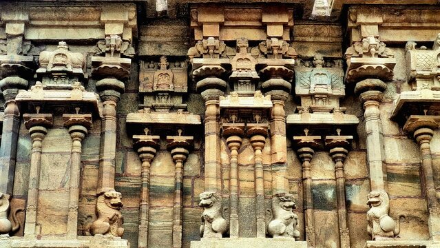 Intricately carved stone wall of a South Indian temple showcasing traditional Dravidian architecture with mythical Yali sculptures and ornate columns, located at Azhagar Temple, Madurai, Tamil Nadu