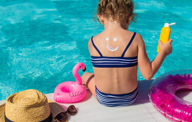 The child has sunscreen on his back. Selective focus.