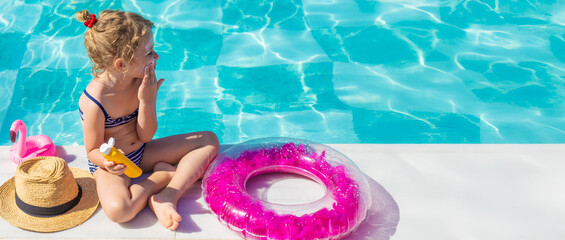 The child has sunscreen on his face. Selective focus.