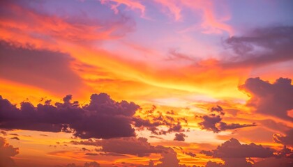 Obraz premium Dramatic sunset sky with fiery orange and purple hues blending in the clouds